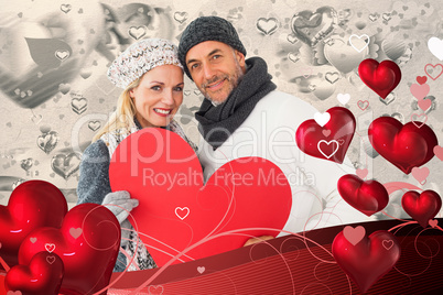 Composite image of smiling couple in winter fashion posing with