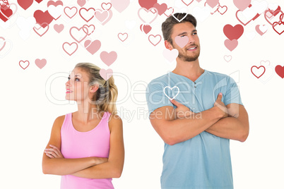 Composite image of young couple posing with arms crossed