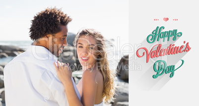 Composite image of gorgeous couple embracing by the coast
