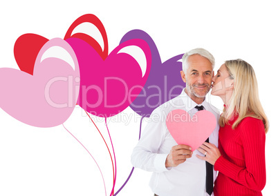 Composite image of handsome man holding paper heart getting a ki