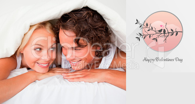 Composite image of couple under a duvet with a knowing smile