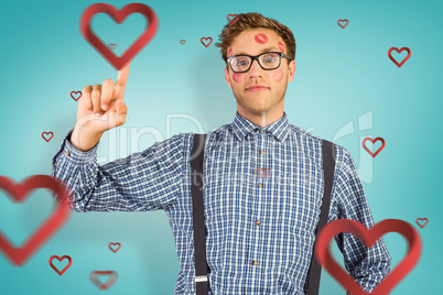 Composite image of geeky hipster covered in kisses