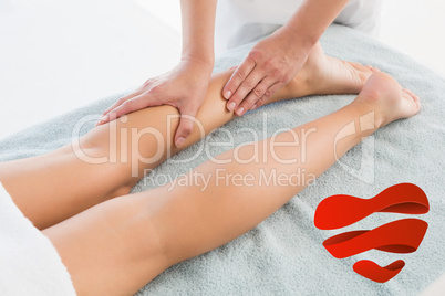 Composite image of woman receiving leg massage at spa center