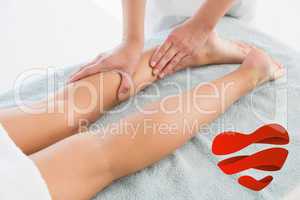 Composite image of woman receiving leg massage at spa center
