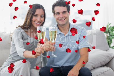 Composite image of portrait of lovers toasting their flutes of c