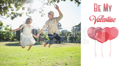 Composite image of cute couple jumping in the park together hold
