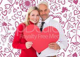 Composite image of handsome man getting a heart card form wife