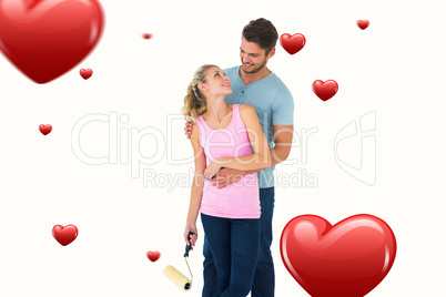 Composite image of young couple painting with roller