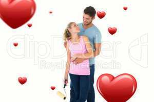 Composite image of young couple painting with roller