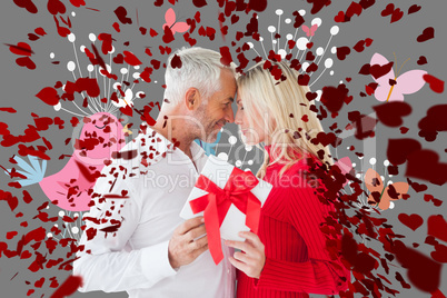 Composite image of loving couple with gift