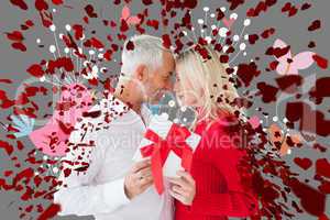 Composite image of loving couple with gift