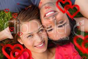 Composite image of close up of two friends looking upwards while