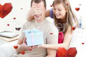 Composite image of smiling woman giving a present to her boyfrie