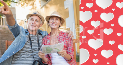 Composite image of happy tourist couple looking at map on a benc