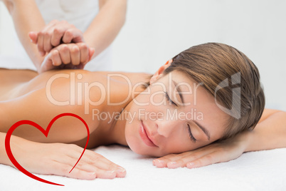 Composite image of attractive woman receiving back massage at sp