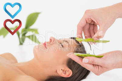 Composite image of attractive young woman receiving aloe vera ma