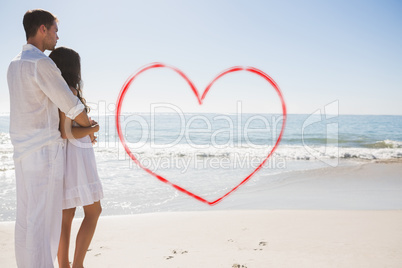 Composite image of attractive couple looking out at sea