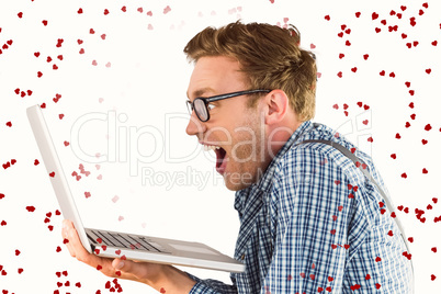 Composite image of geeky businessman using his laptop