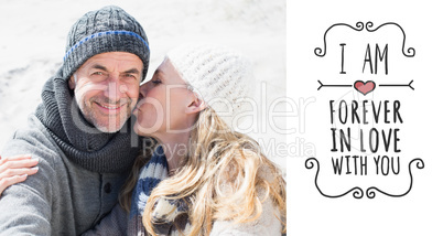 Composite image of attractive couple on the beach in warm clothi