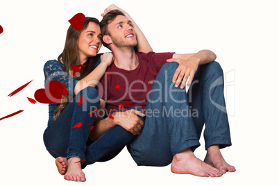 Composite image of young couple sitting on floor