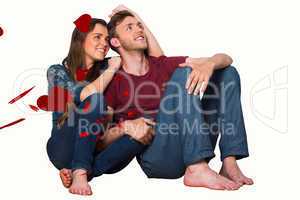 Composite image of young couple sitting on floor