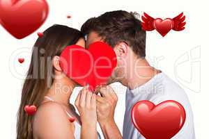 Composite image of side view of romantic couple holding heart