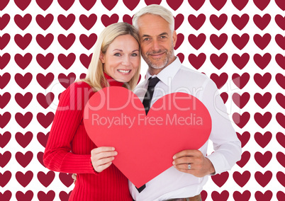 Composite image of handsome man getting a heart card form wife