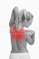 Rear view of topless woman with neck pain