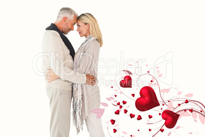 Composite image of happy couple standing and hugging