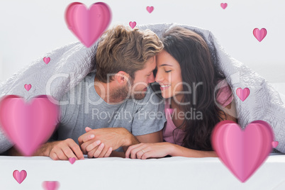 Composite image of cheerful couple head against head under the d