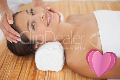 Composite image of beautiful brunette enjoying a head massage