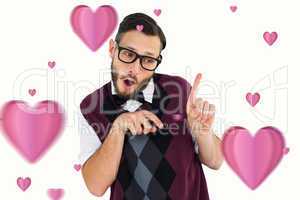 Composite image of geeky hipster in sweater vest pointing