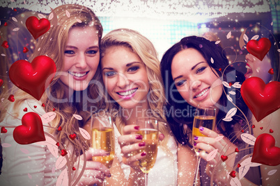 Composite image of pretty friends drinking champagne together