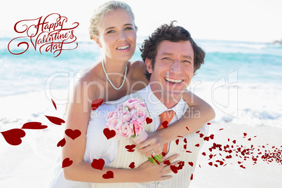 Composite image of handsome groom giving his new wife a piggy ba