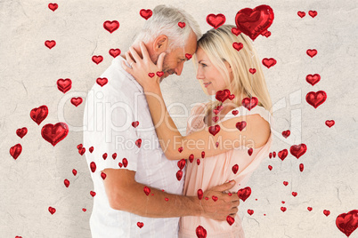 Composite image of affectionate couple standing and hugging