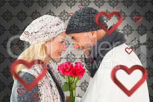 Composite image of smiling couple in winter fashion posing with