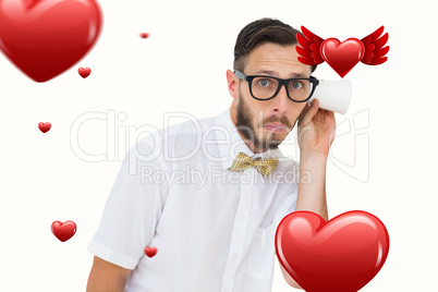 Composite image of geeky businessman eavesdropping with cup
