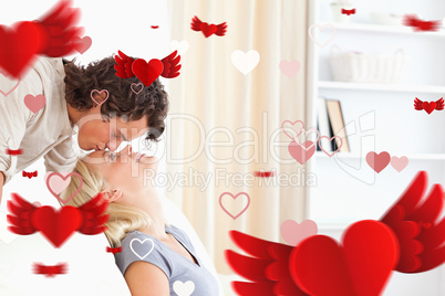 Composite image of man kissing his girlfriend on the forehead