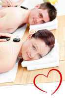 Composite image of cute young couple receiving a back massage wi