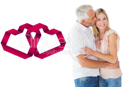 Composite image of affectionate man kissing his wife on the chee