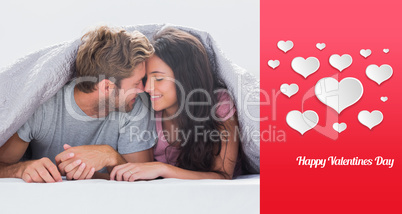 Composite image of cheerful couple head against head under the d