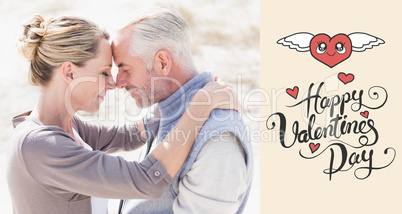 Composite image of happy hugging couple on the beach looking at