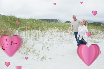 Composite image of cheerful senior couple walking at beach