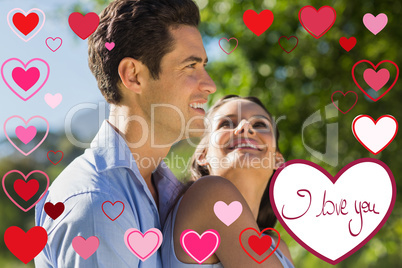 Composite image of loving and happy young couple at park