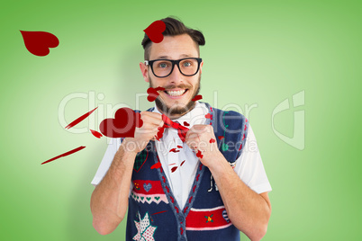 Composite image of geeky hipster wearing christmas vest