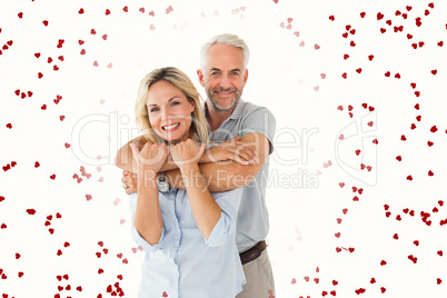 Composite image of happy couple standing and hugging Composite image of happy couple standing and hugging