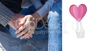 Composite image of couple holding hands sitting on sand