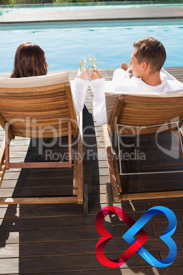 Composite image of couple toasting champagne by swimming pool