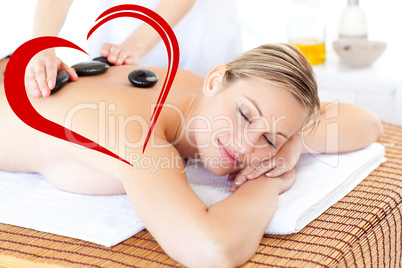 Composite image of pretty young woman receiving a massage with h