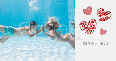 Composite image of cute couple kissing underwater in the swimmin